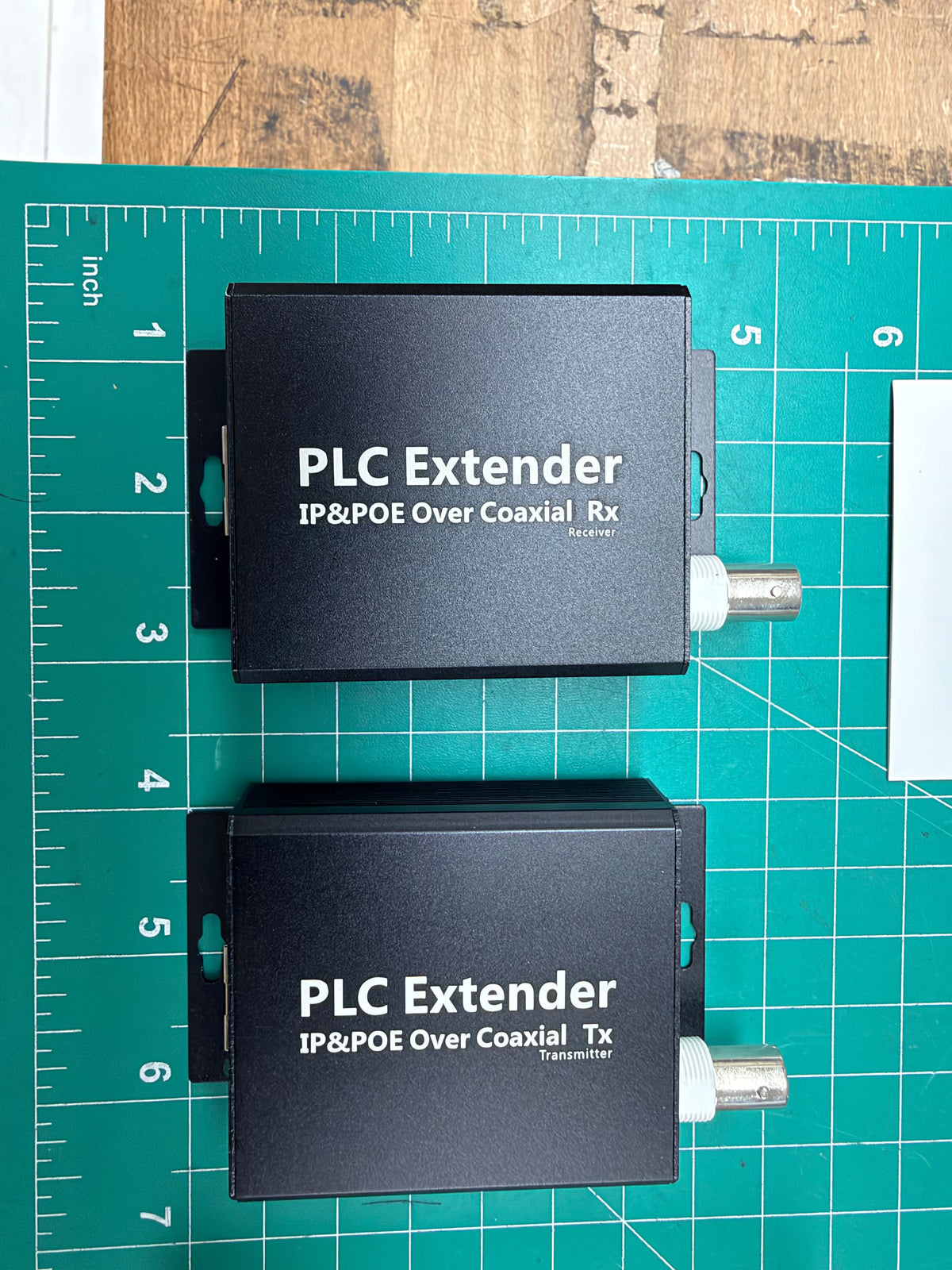 OTK-POE-COX receiver and transmitter on an inch ruler